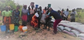 Ntengula (R) with members of community.