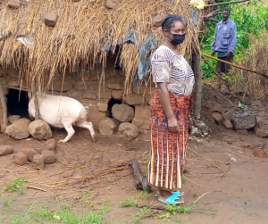 Zimba stands in front of her pig khola