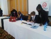 Finance Minister Felix Mlusu signing an agreement